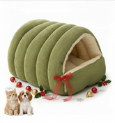 Green pet bed with a red bow, surrounded by Christmas decorations and two small animals on a white background.