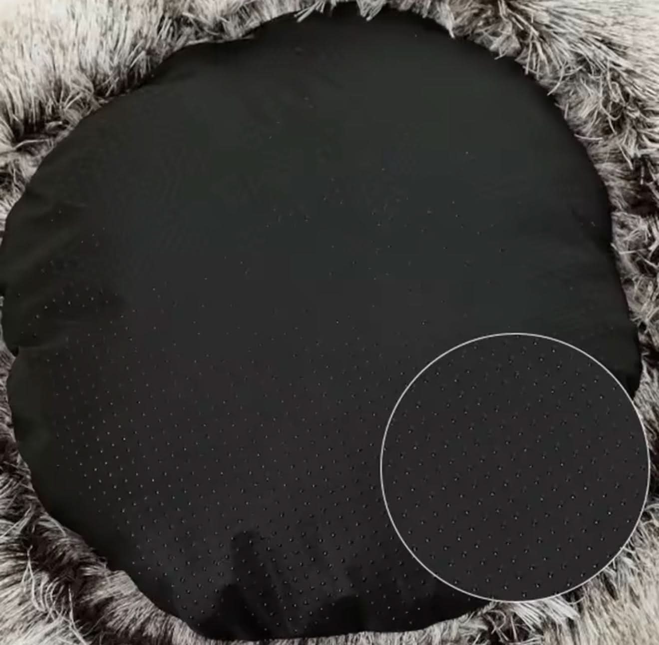 Black round cushion on a textured surface
