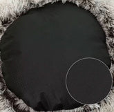 Black round cushion on a textured surface