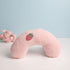 Pink neck pillow with a strawberry design on a light blue background