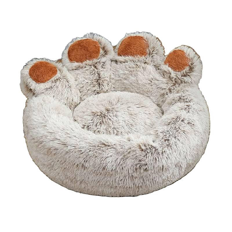 Plush round pet bed shaped like a paw, soft beige fur with brown accents, cozy design.