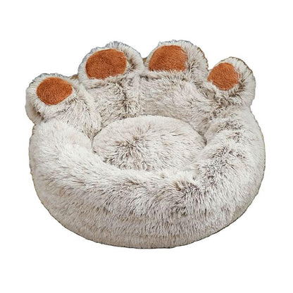 Plush round pet bed shaped like a paw, soft beige fur with brown accents, cozy design.