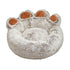 Plush round pet bed shaped like a paw, soft beige fur with brown accents, cozy design.
