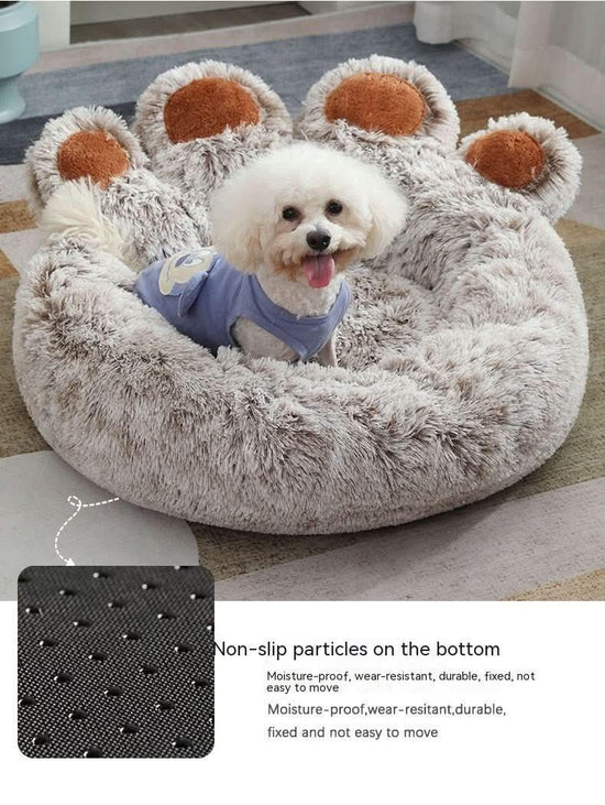 Small white dog sitting in a plush paw-shaped pet bed with non-slip bottom and fluffy texture.