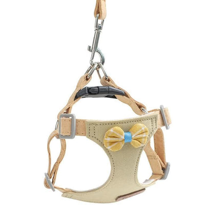 Beige mini dog harness and leash set with yellow bow, adjustable straps, metal clips