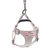 Light pink pet harness and leash set with bow detail, adjustable straps, and clip closure.
