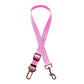 Pink adjustable dog car seat belt with metal clip and buckle on white background