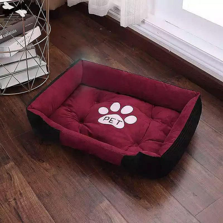 Plush rectangular winter pet bed for dogs and cats with a paw print design on a wooden floor