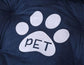 Close-up of a navy blue plush pet bed with a white paw print and the word &