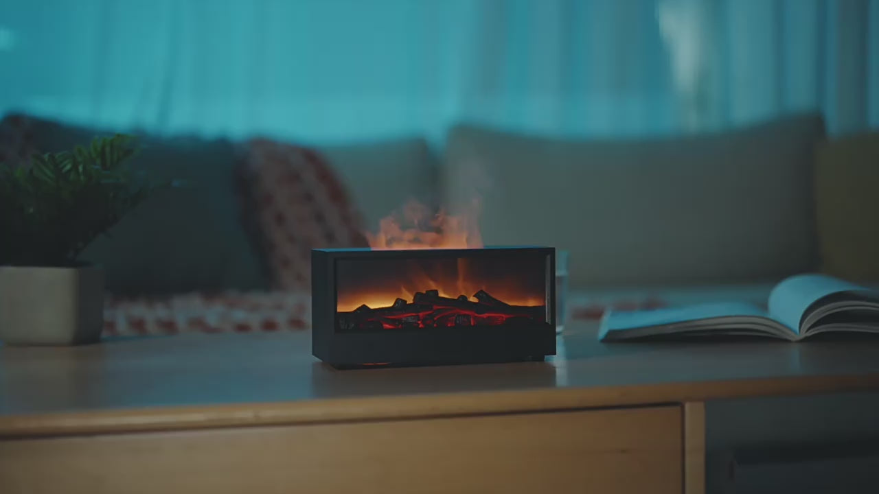 video for fire aroma diffuser showing the use of the product in a hoe on top of coffee table and diffuser is on working mode with a lady sitting on the coach enjoying the smell and the atmosphere.