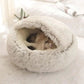 Cat sleeping in a semi-closed, fluffy round pet bed on a soft white carpet.