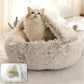 Fluffy cat in a semi-enclosed plush pet bed on a cozy indoor surface